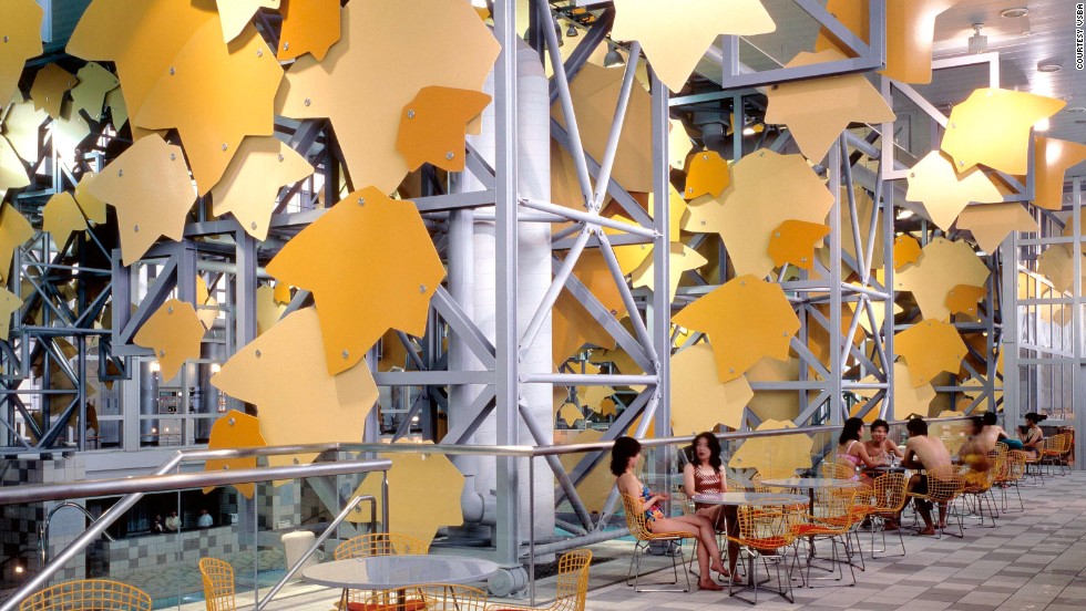 The spa facade is ornamented with giant green and yellow aluminum tree leaves. 