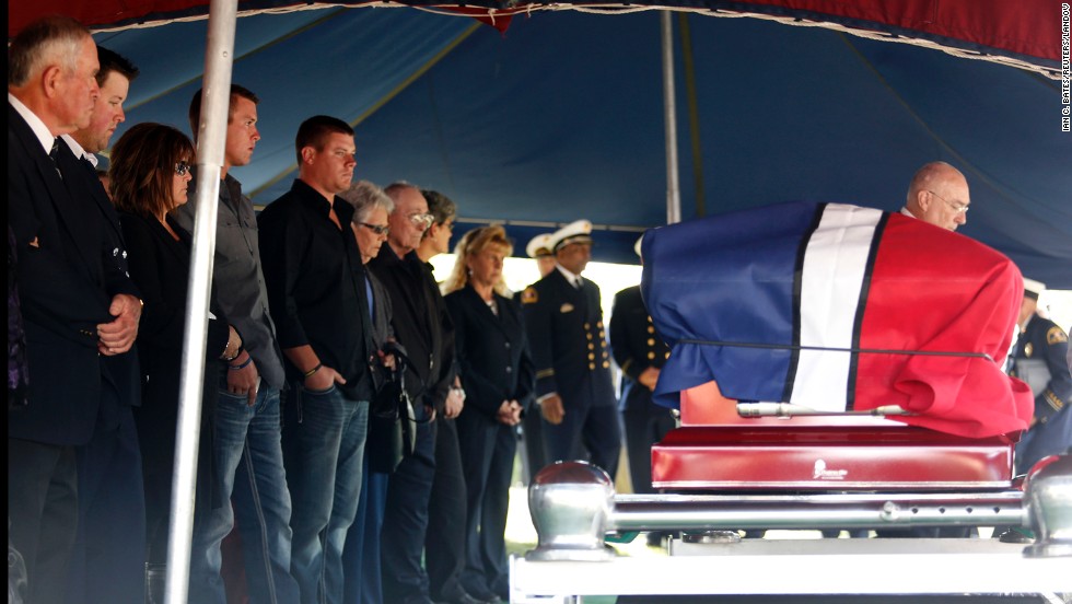 Family and friends stand in front of Harris&#39; casket at the cemetery on April 24.