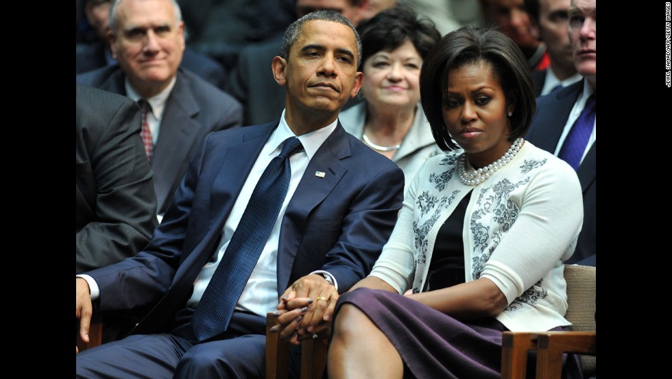 The President and first lady hold hands during a memorial service for the victims of a Tucson, Arizona, shooting. On January 8, 2011, Jared Lee Loughner shot six people and wounded 13 more, including then-Rep. Gabrielle Giffords.