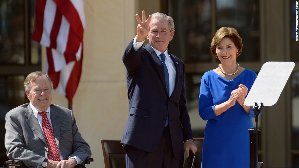 George W. Bush gestures a &quot;W&quot; to the crowd after speaking.