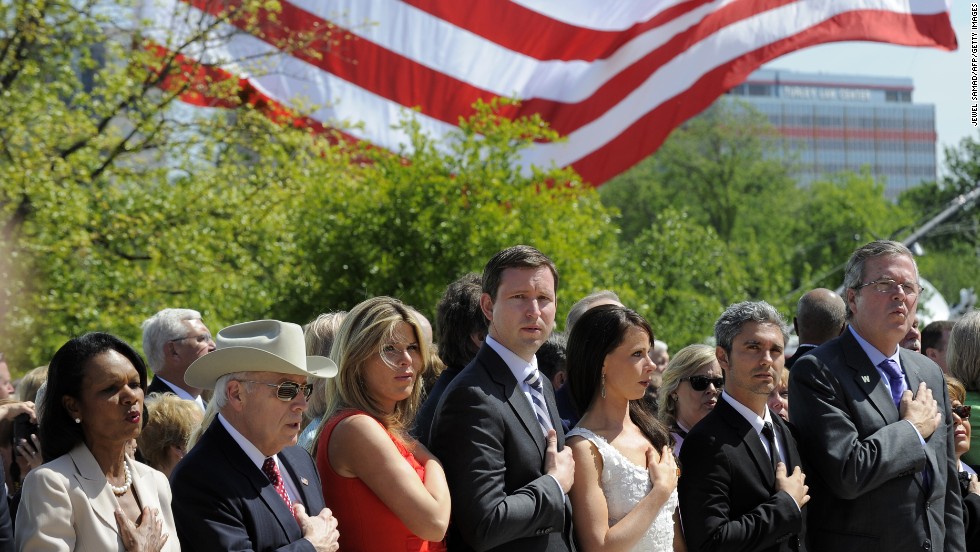 Left to right: former Secretary of State Condoleezza Rice, former Vice President Dick Cheney, Jenna Bush Hager, her husband Henry Hager, Barbara Bush, Miky Febrega,  and former Florida Gov. Jeb Bush sing the national anthem at the ceremony.