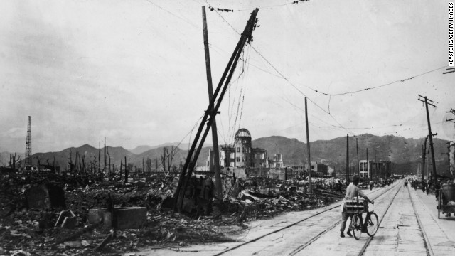 A man wheels his bicycle thorough Hiroshima in August 1945, days after the city was leveled by an atomic bomb blast.