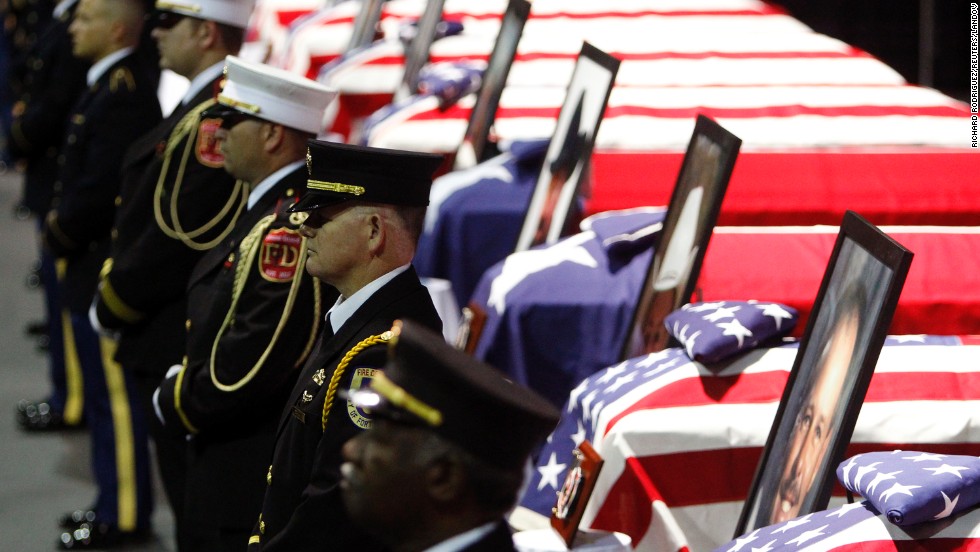 A firefighters honor guard stands before the coffins of fallen comrades on April 25.