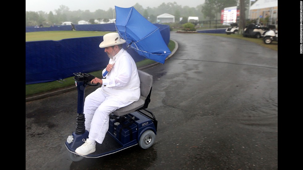 Chef Paul Prudhomme heads to the Zurich Classic Pro-Am clubhouse at TPC Louisiana as officials order the evacuation of all temporary structures after a tornado warning in New Orleans on Wednesday, April 24.