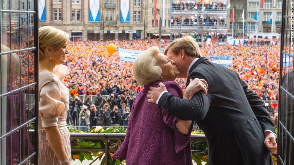 Princess Beatrix of the Netherlands kisses her son, the now King Willem-Alexander as the now Queen Maxima looks on during a short address to the public after Queen Beatrix abdicated ahead of the investiture of Willem-Alexander on Tuesday, April 30, in Amsterdam, in this image provided by Netherlands Government Information Service.