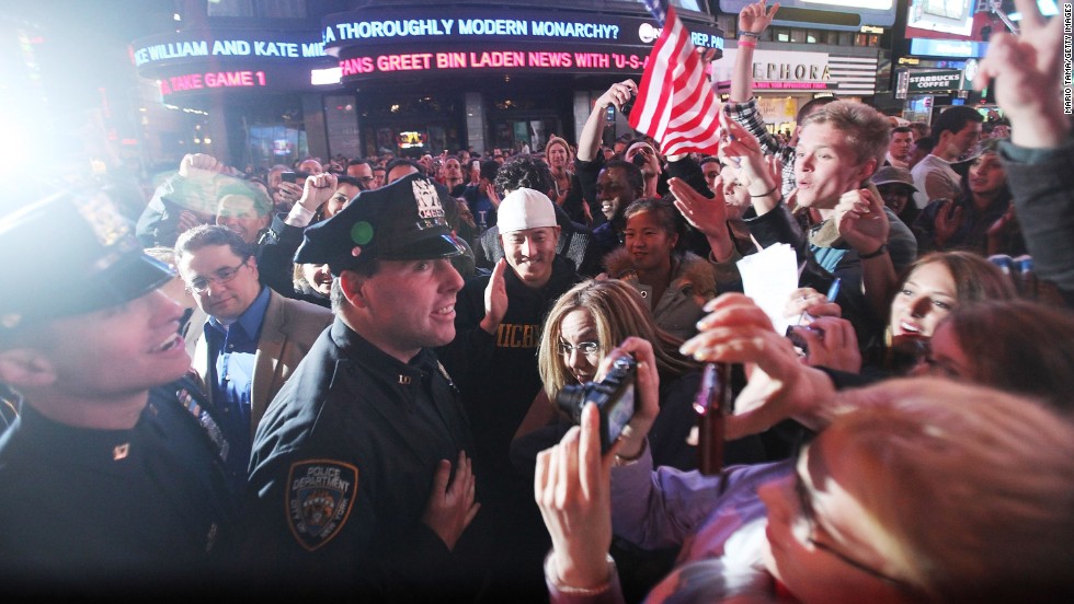 Crowds celebrate with NYPD officers in New York&#39;s Times Square early on May 2, 2011, after the death of Osama bin Laden.