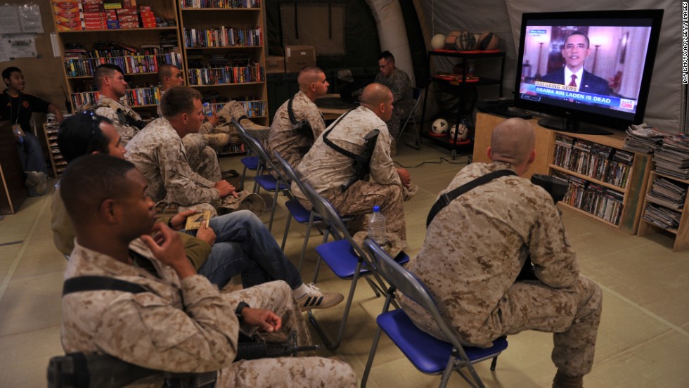 U.S. Marines watch the announcement of bin Laden&#39;s death at Camp Dwyer in Helmand Province, Afghanistan.