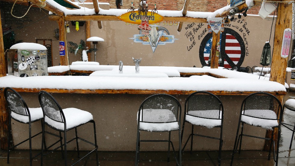 Snow covers an outdoor bar in downtown Golden, Colorado, after a spring storm dumped more than a foot of snow on Wednesday, May 1. In nearby Denver, the average date for the last snow of the season is April 26, but the record for the latest snowfall was set June 12, 1947, according to the National Weather Service.