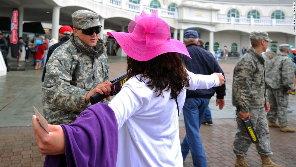 Security personnel check fans entering Churchill Downs. The Kentucky Derby is the largest U.S. sporting event since the April 15 bombings at the Boston Marathon.