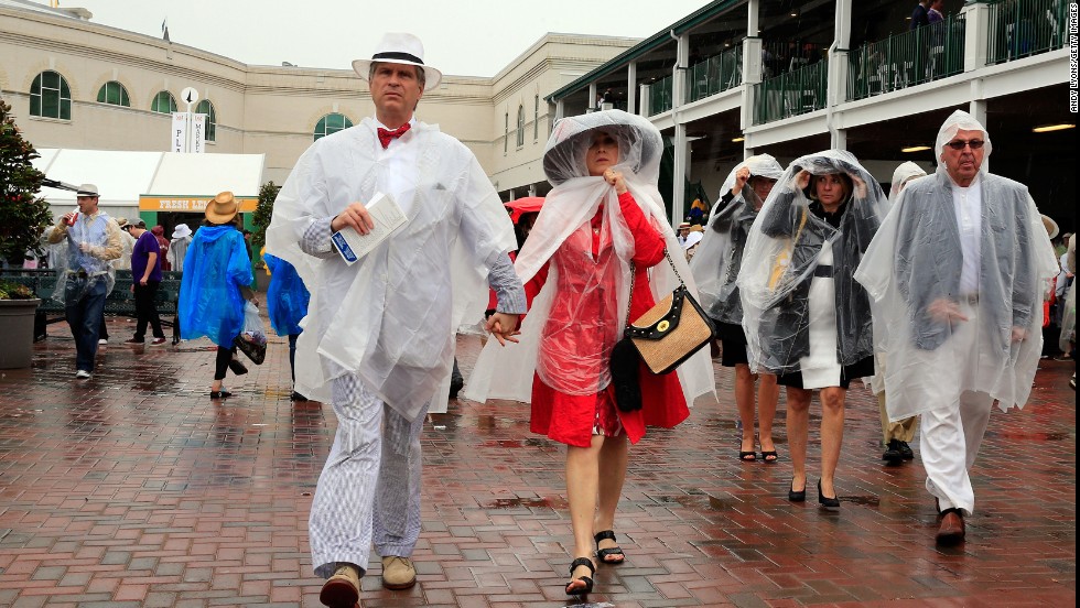 Plastic rain slickers mute the fashions of Derby attendees.
