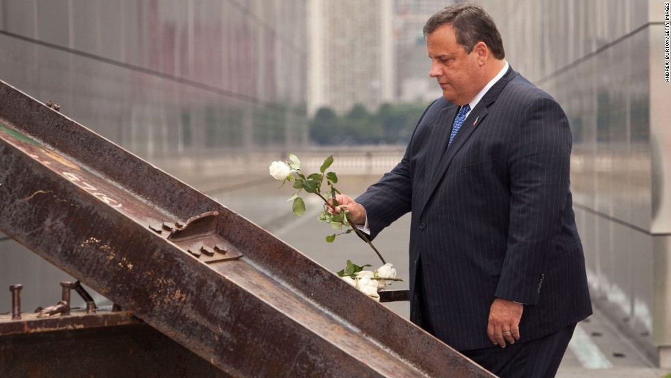 Christie lays a white rose on wreckage pulled from ground zero during the dedication for the Empty Sky Memorial at Liberty State Park on September 10, 2011, in Jersey City, New Jersey.