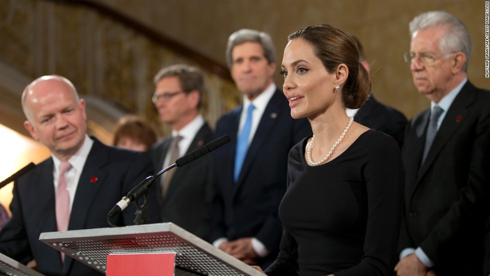 Jolie has become an influential diplomatic personality, meeting with world leaders through her work with the UN. British Foreign Secretary William Hague (L) listens as Jolie speaks on the issue of sexual violence against women during a G8 Foreign Ministers meeting in London on April 11, 2013. 