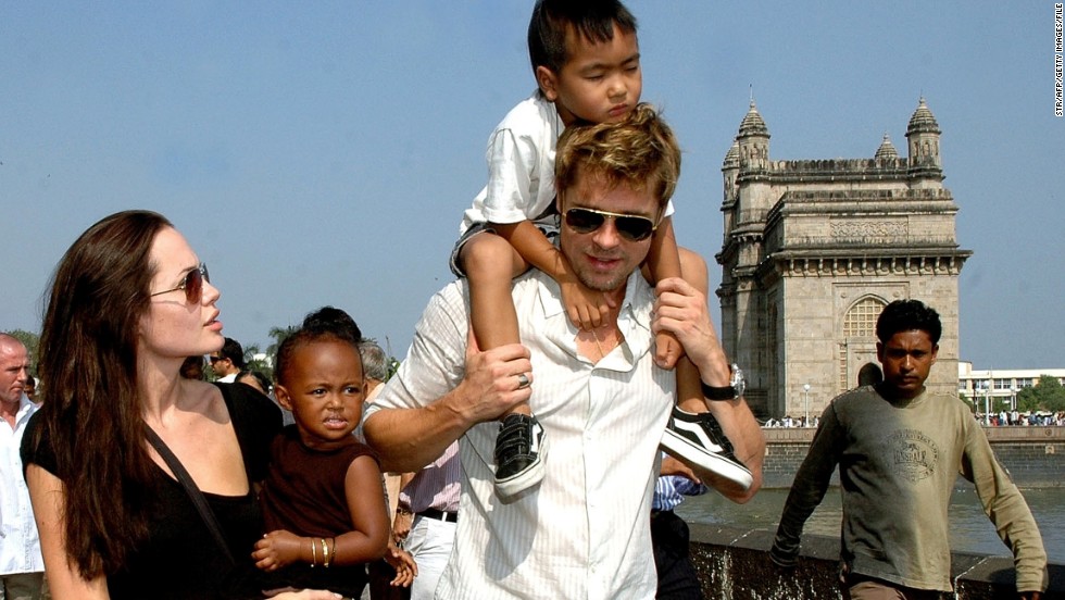 Here the proud mother holds daughter Zahara as partner Brad Pitt carries son Maddox during a stroll on the seafront promenade at the historic Gateway of India outside their hotel in Mumbai on November 12, 2006. 