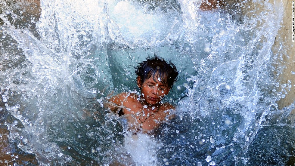 A boy cools off in a watering hole in Allahabad, India, on Saturday, May 18, where temperatures have reportedly reached 117.1 degrees Fahrenheit. 