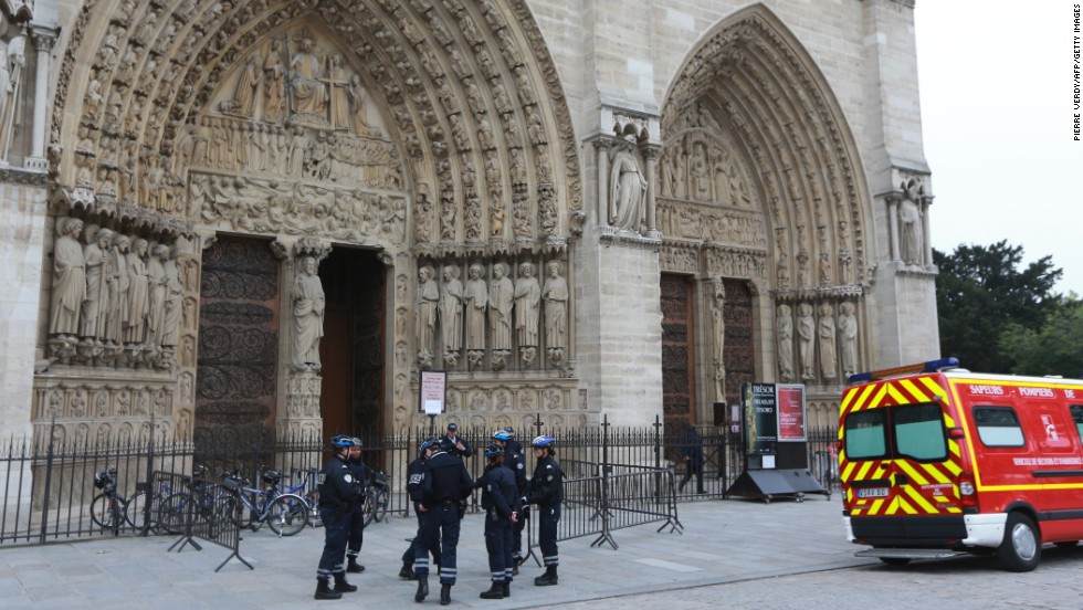 French police stand outside Paris&#39; Notre Dame Cathedral on Tuesday, May 21, following the evacuation of the cathedral after a man shot himself dead in front of the altar. Historian and writer Dominique Venner killed himself in front of horrified tourists after denouncing same-sex marriage and immigration. 