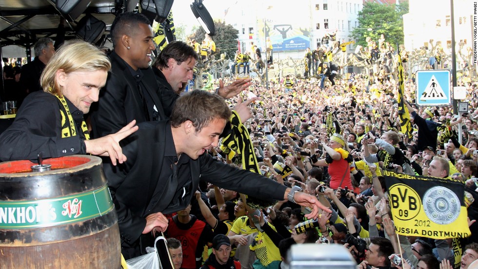 Gotze celebrates with colleagues and fans as Dortmund celebrate their 2012 league and cup double. 