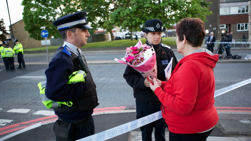 Mary Warder brings flowers to the scene of the crime on May 22 to pay respects to the victim.