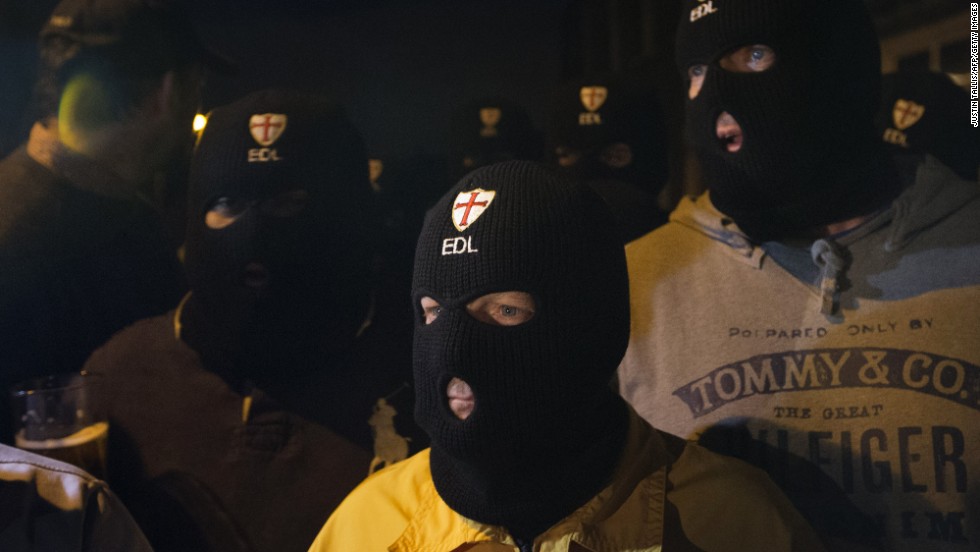 Members of the far-right English Defence League wear balaclavas as they gather outside a pub in Woolwich on Wednesday, May 22.