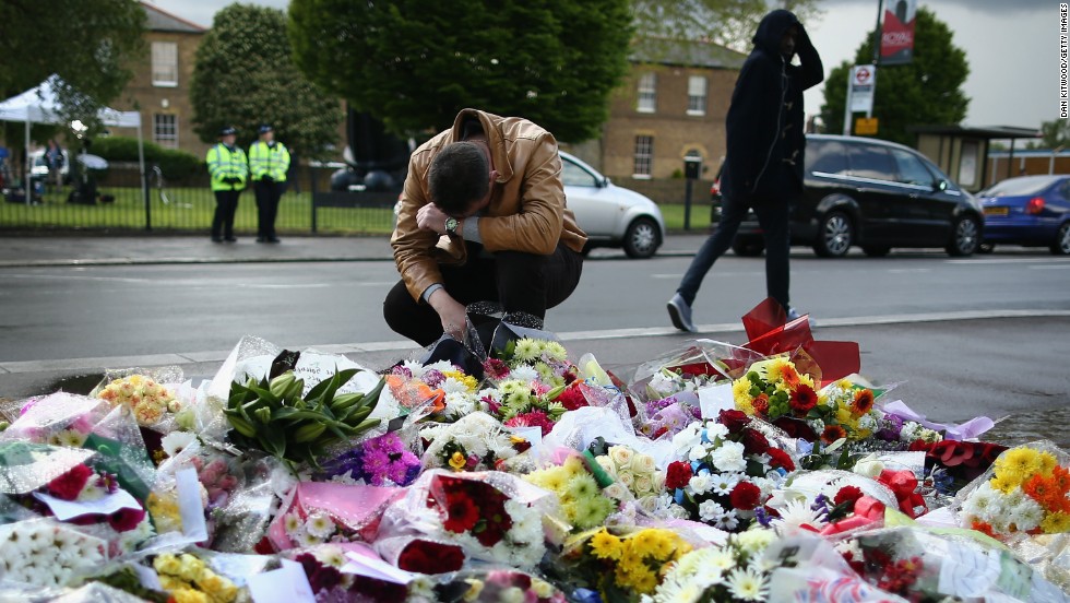 A man contemplates the makeshift memorial outside Woolwich Barracks in London.
