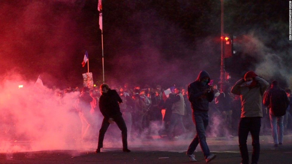 Protesters stand in the street as they face riot police on Sunday, May 26, in Paris on the sidelines of demonstrations against a gay marriage law legalizing same-sex marriage and adoptions for gay couples. President Francois Hollande s&lt;a href=&quot;http://www.cnn.com/2013/05/18/world/europe/france-same-sex-marriage/index.html&quot;&gt;igned the measure into law&lt;/a&gt; on May 18 following months of bitter debate and demonstrations, including &lt;a href=&quot;http://www.cnn.com/2013/05/21/world/europe/france-cathedral-death/index.html&quot;&gt;a suicide &lt;/a&gt;at Notre Dame Cathedral in the name of protesting same-sex marriage.