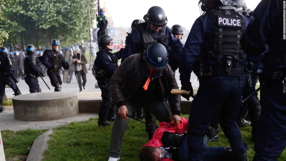 Riot police arrest a protester on May 26.
