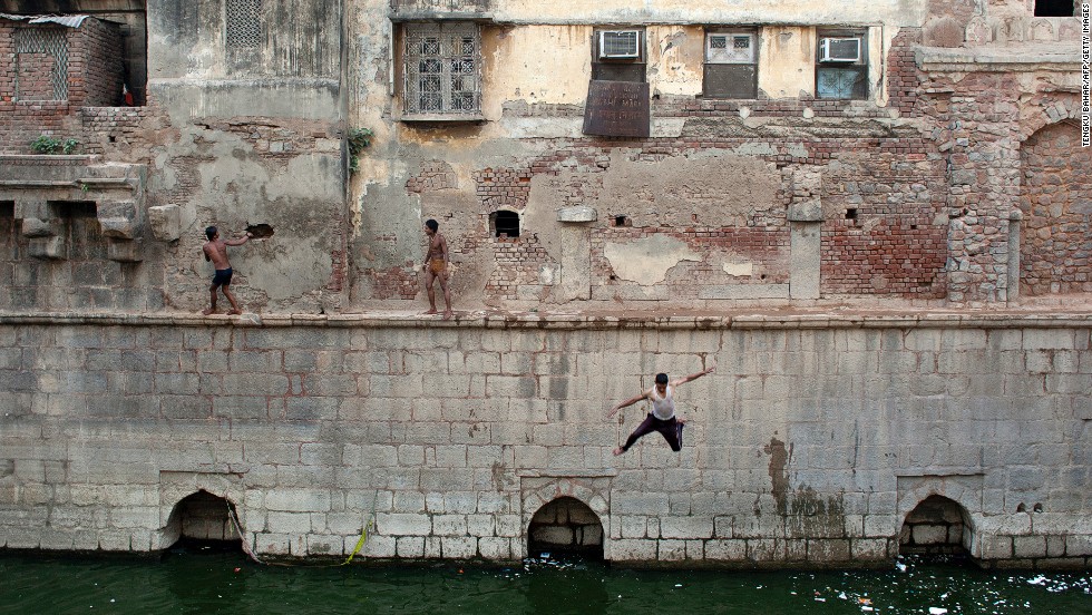 Indian youth jump from a wall into the Nizamuddin Baoli on a hot day in New Delhi, India, on May 28. 