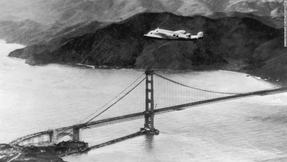 The Lockheed Electra &#39;Flying Laboratory&#39; piloted by Earhart and Fred Noonan flies over the Golden Gate bridge in Oakland, California, at the start of a planned around-the-world flight on March 17, 1937. The trip had to be abandoned after the plane crashed on takeoff in Hawaii.