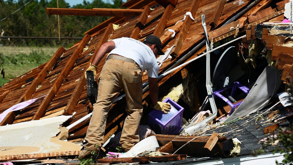 A man searches through the rubble of a home in El Reno on June 1. A large part of Moore, Oklahoma, was without power, as were parts of El Reno and Union City.