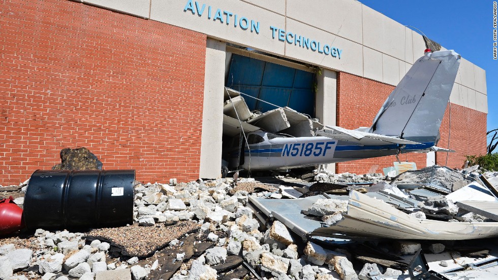 The tail section of a plane juts out of a crumbling building at a technology school in El Reno on June 1. 