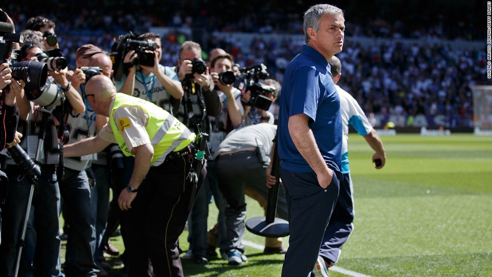 Photographers gather around Jose Mourinho during his last match as coach of Real Madrid, a 4-2 win at home to Osasuna. Real finished the season 15 points behind Spanish champions Barcelona.  