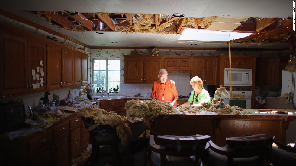 Bill Thesing, who was injured in his home when a tornado hit, returns from the hospital to to salvage items from his home with the help of his friend Tammy Hicks on Saturday, June 1, in El Reno, Oklahoma.