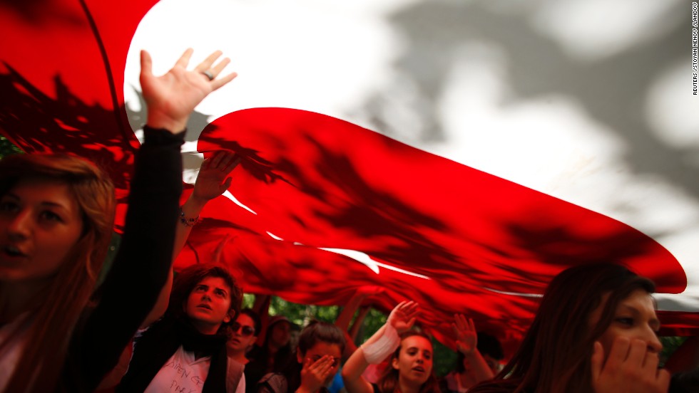 Despite Turkish Prime Minister Recep Tayyip Erdogan&#39;s call for calm on Monday, June 3, protests continued in Istanbul. Protesters carry the Turkish flag and shout against the government in Gezi Park near central Istanbul.
