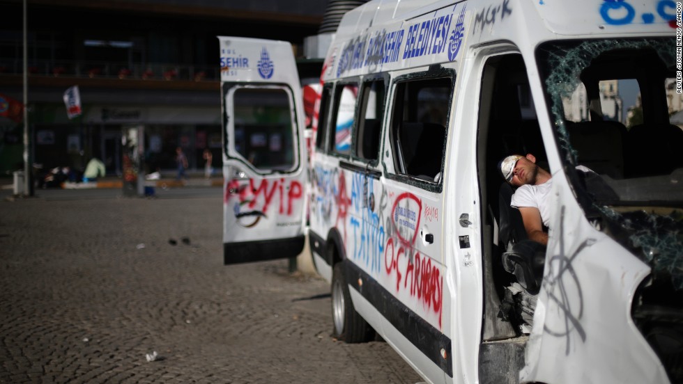After protests that lasted until the early morning, a protester sleeps in a damaged and vandalized vehicle in Taksim Square on June 3. Protests showed no sign of letting up on Monday, almost a week after a peaceful sit-in was met with a police crackdown, igniting the biggest anti-government riots the city has seen in a decade.