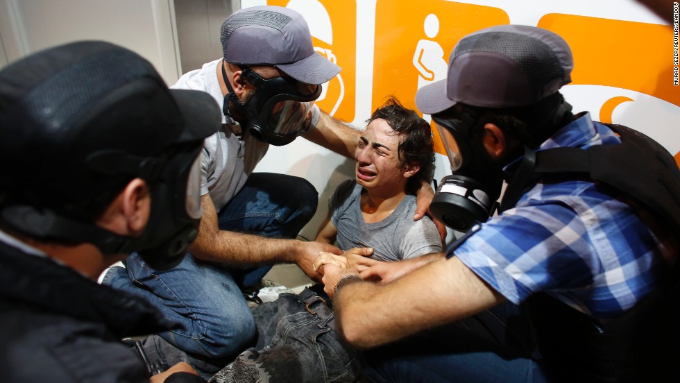 Police officers tend to a demonstrator during the violent clashes in Istanbul on June 3.