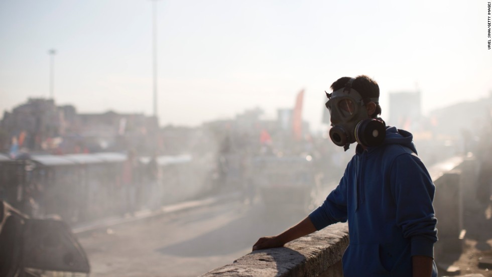 A protester wears a gas mask as smoke from a burned car fills the air at Taksim Square on June 3.