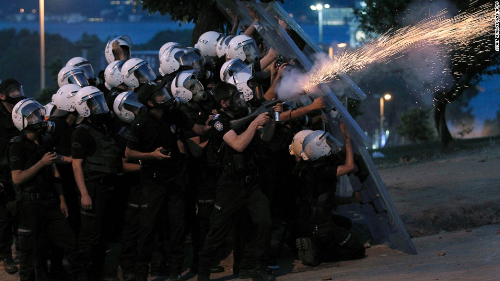 Turkish riot police fire tear gas canisters to disperse protesters near Taksim Square on June 3.