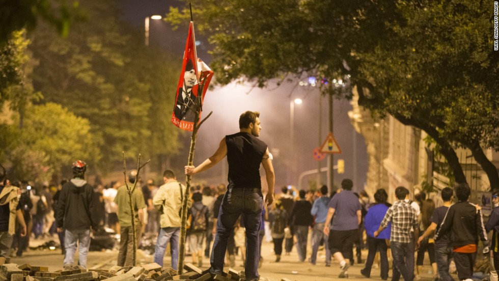 A protester looks on during clashes with Turkish police outside of Prime Minister Recep Tayyip Erdogan&#39;s office, near Taksim Square in Istanbul on Tuesday, June 4. 