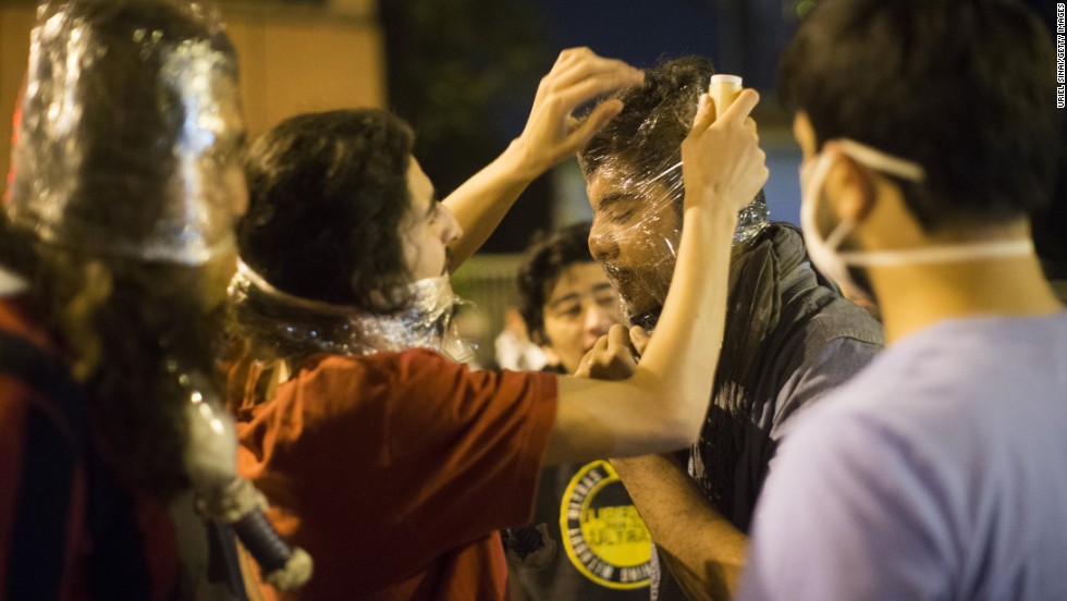 Protesters cover their faces with plastic. After chaotic scenes in the streets Monday that continued late into the night and sent tear gas wafting through the air, the situation was relatively calm on Tuesday morning in Istanbul&#39;s central Taksim Square, near the park where the movement began.