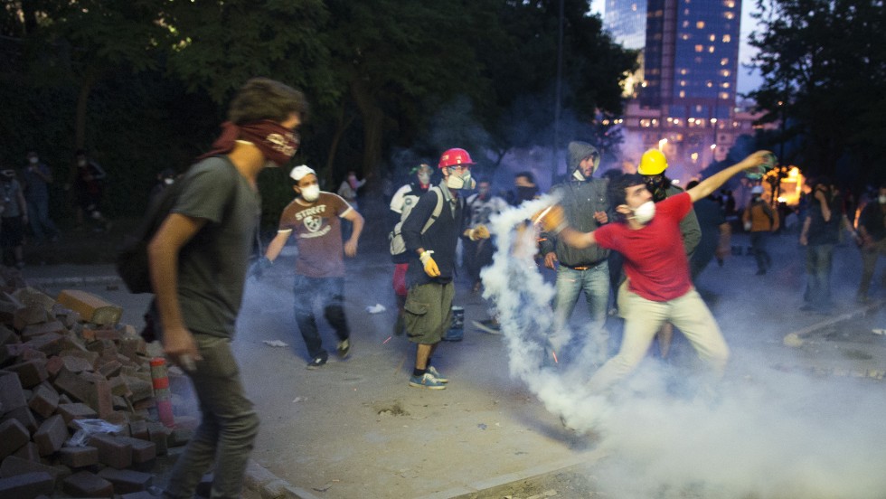 Protesters throw riot police&#39;s tear gas back at them in Istanbul on June 3.