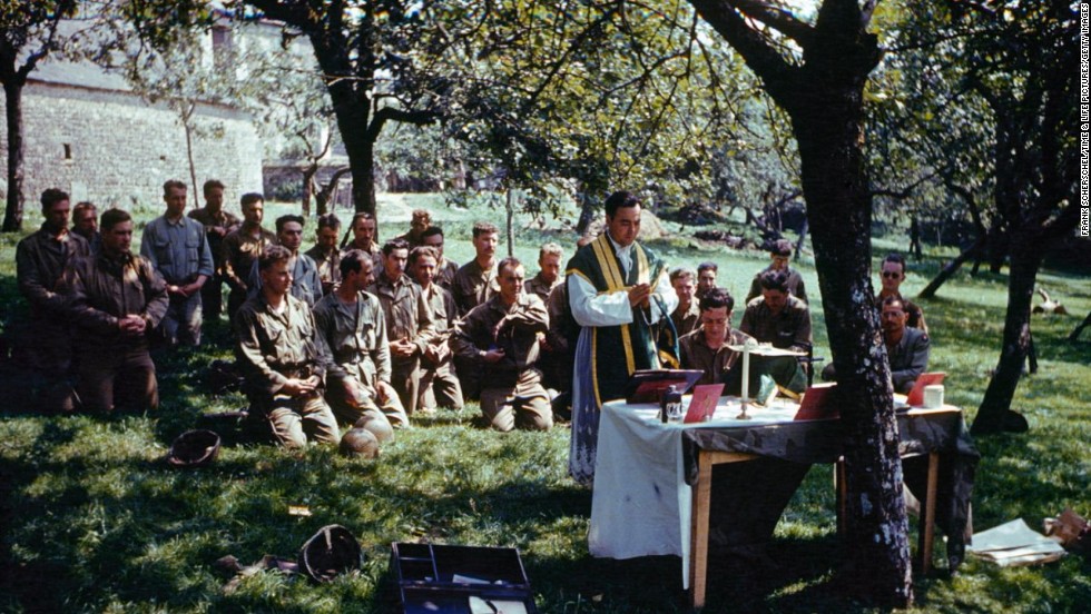 A church service is conducted in dappled sunlight, France, 1944.