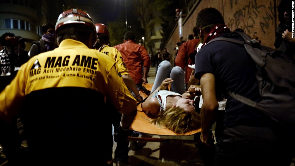 Paramedics carry a woman injured during clashes between demonstrators and riot police in Istanbul on June 4.