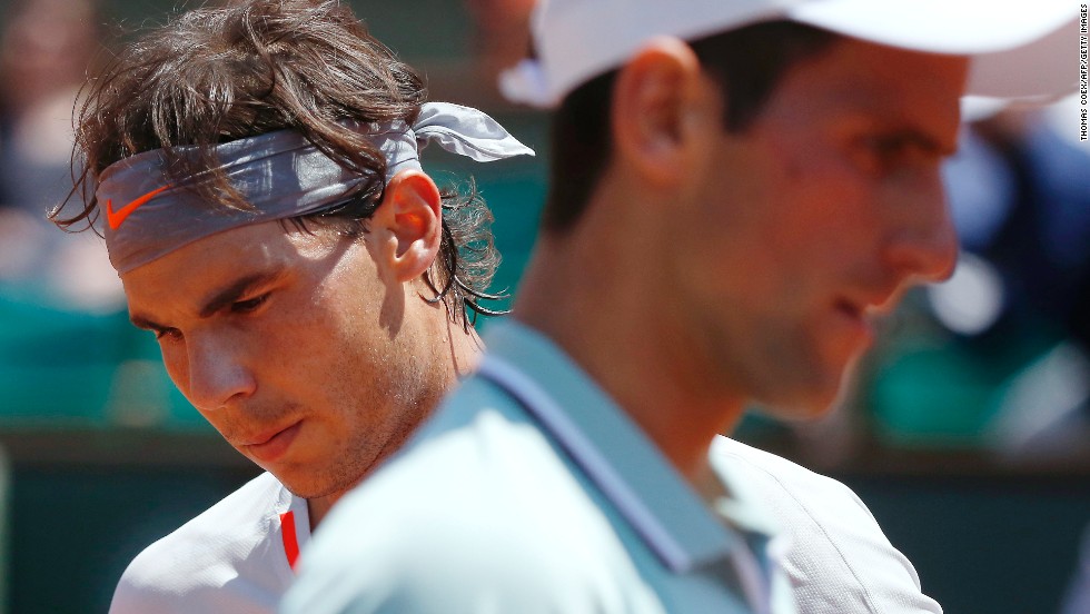 Nadal, left, and Djokovic change sides during their June 7 match.