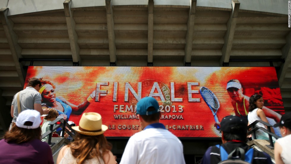 Tennis fans watch the big screen outside Court Suzanne Lenglen in Paris before the match between Williams and Sharapova.