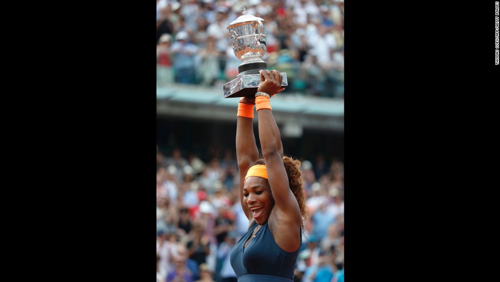 Williams celebrates with the Coupe Suzanne Lenglen trophy following her victory.