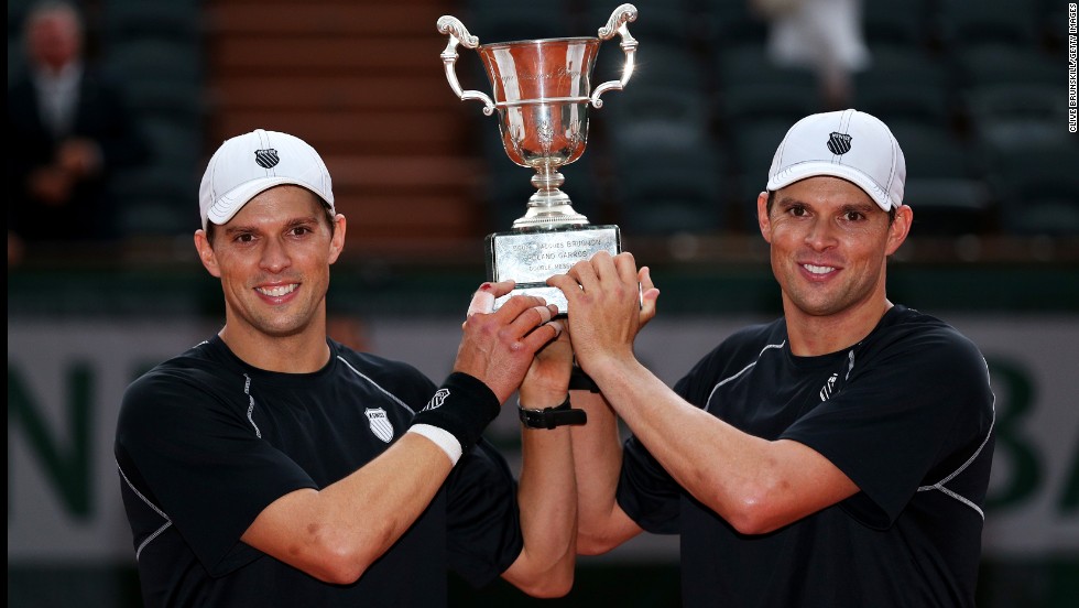  Bob Bryan and Mike Bryan pose with the trophy after winning the men&#39;s doubles final against Michael Llorda and Nicolas Mahut of France on June 8. The twins won 6-4, 4-6, 7-6(4).