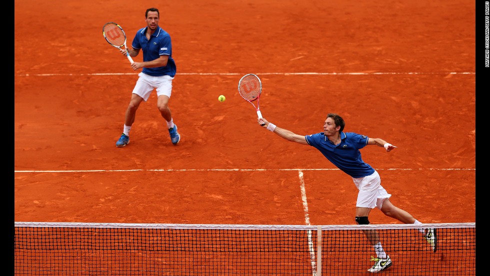 Mahut plays a forehand as his partner Llorda stands ready in the men&#39;s doubles final match.