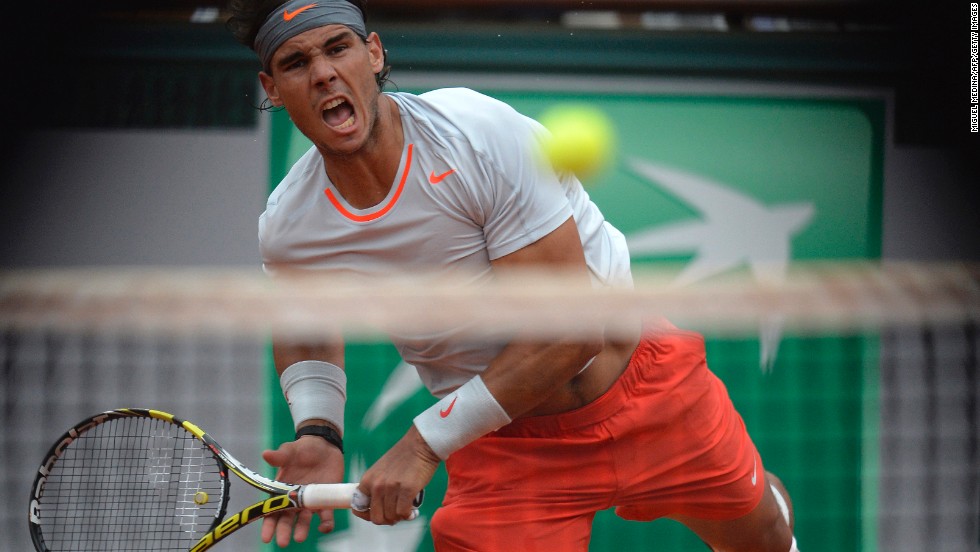 Spain&#39;s Rafael Nadal serves to Spain&#39;s David Ferrer during the men&#39;s singles final match of the French Open at Roland Garros Stadium in Paris on Sunday, June 9.