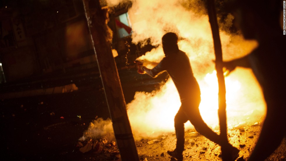 A demonstrator runs toward police during clashes with riot police in Istanbul, on Saturday, June 8.