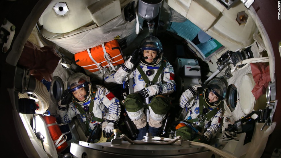 Xiaoguang, left, Haisheng and Yaping sit in a simulated spaceship capsule on April 29.