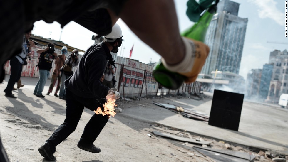Protesters hold molotov cocktails in Taksim Square on June 11.